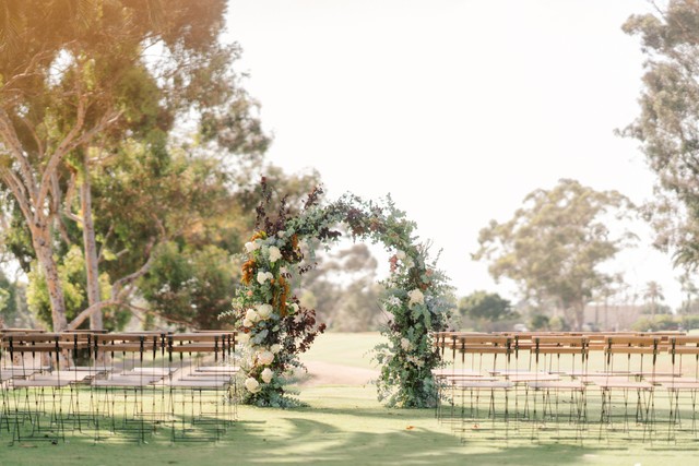 Floral arch at an outdoor wedding ceremony