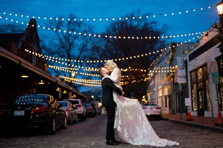 Groom lifts his bride for a kiss