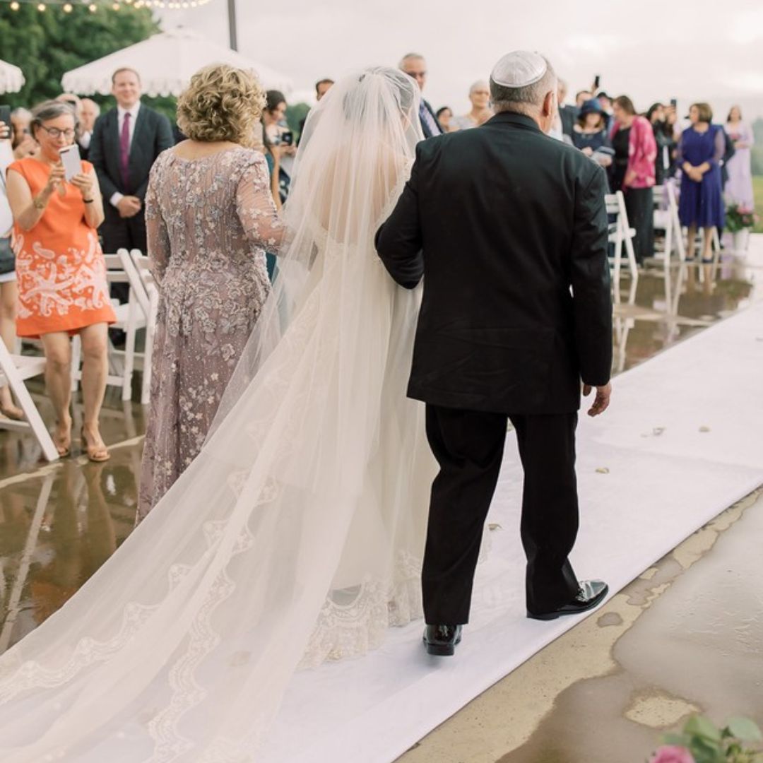 Parents walk their bride down the aisle