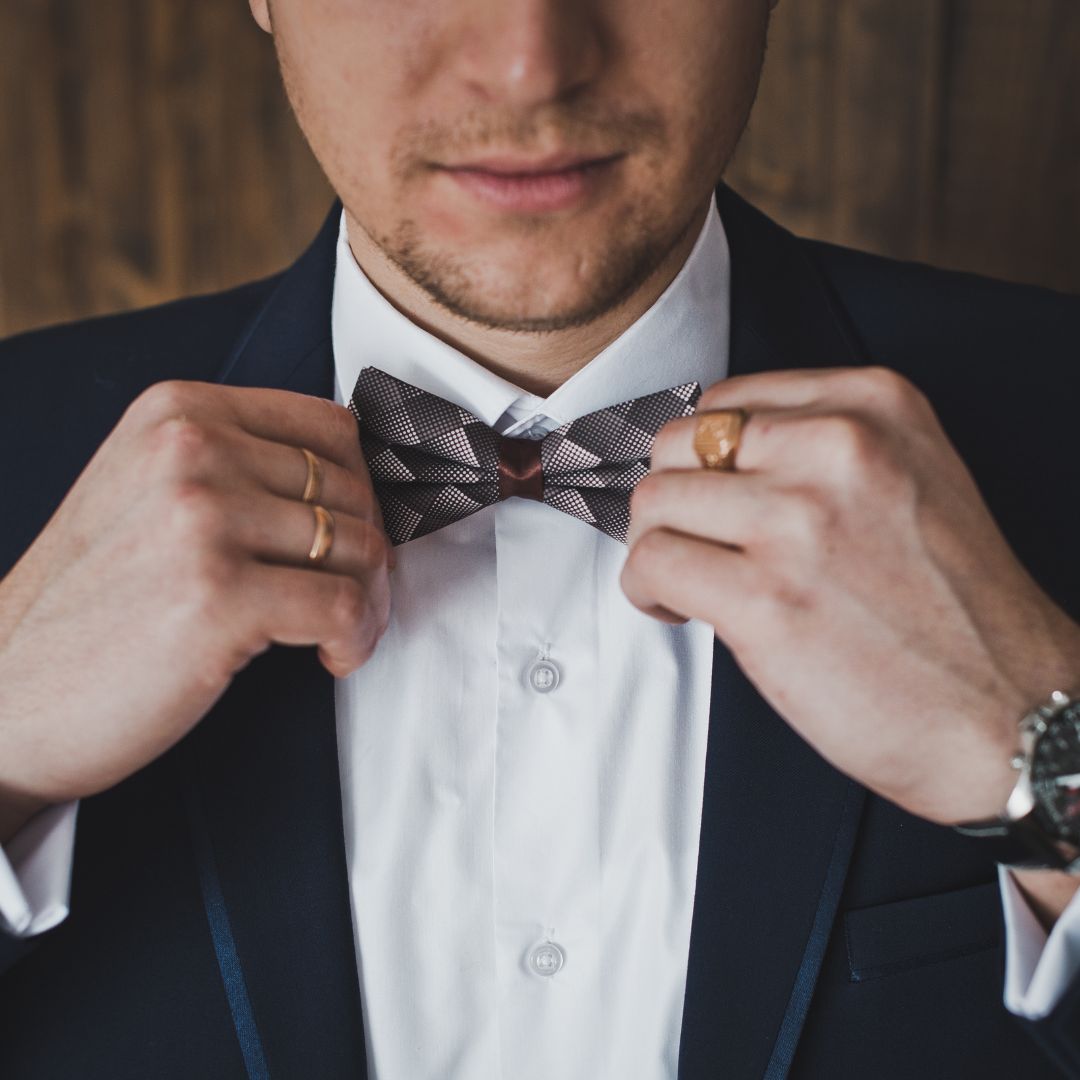 Groom wears a bow tie